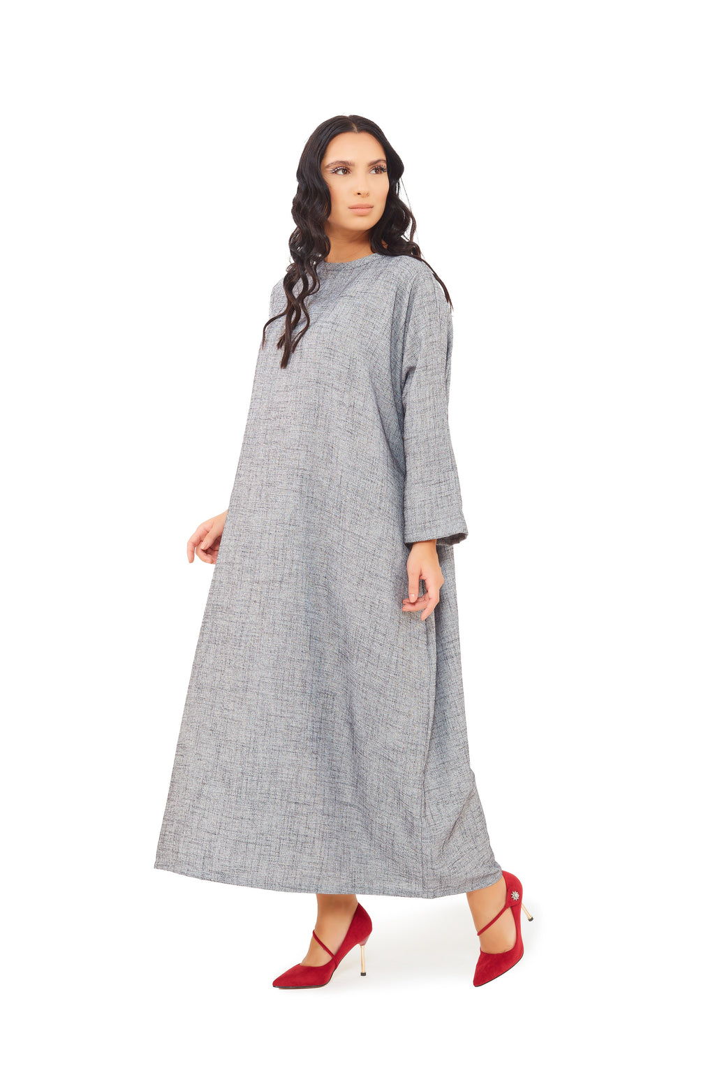 side look of Grey jalabiya dress featuring a round neckline with loose long sleeves and a loose silhouette. 